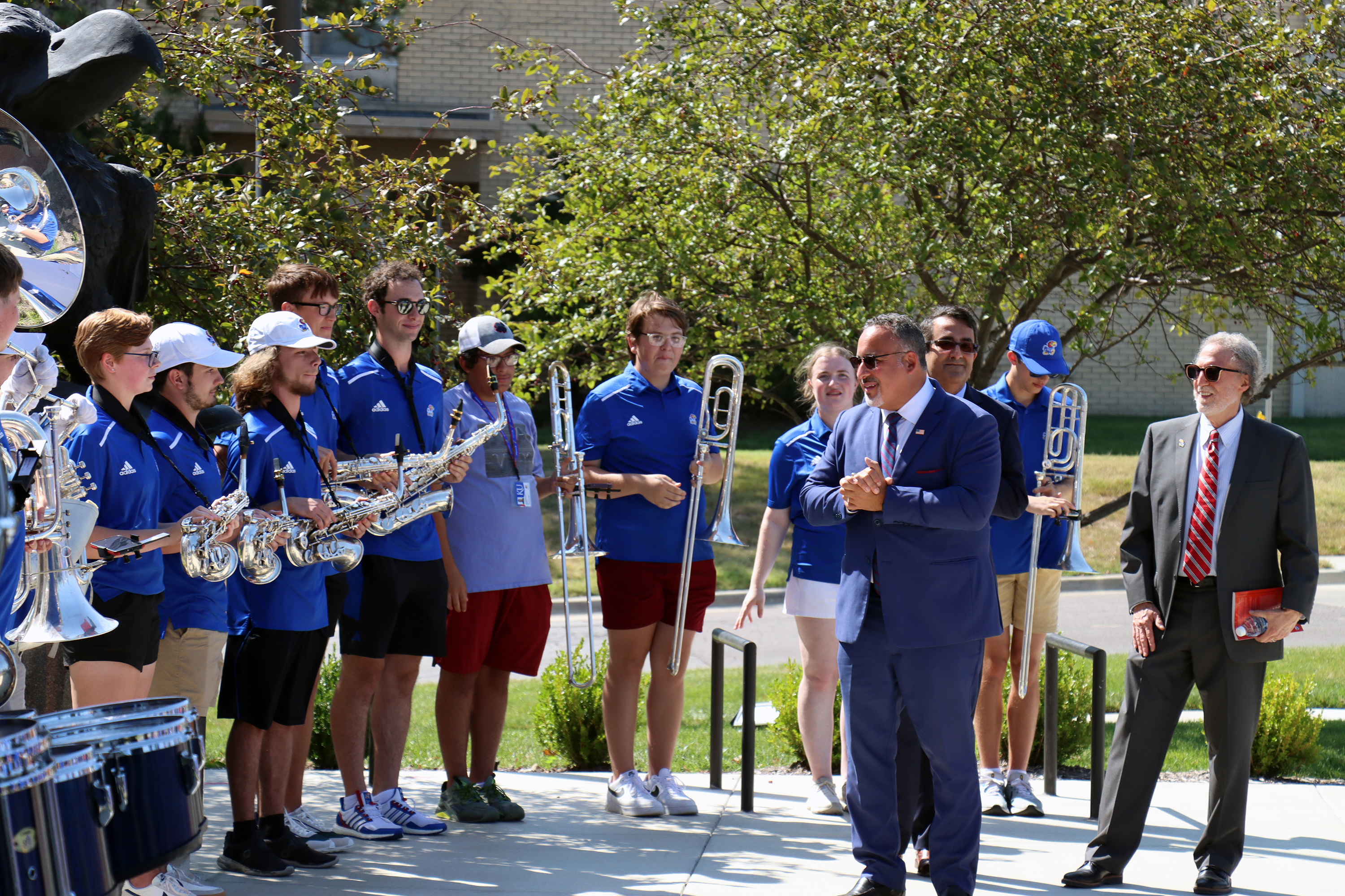 U.S. Secretary of Education Miguel Cardona addresses the KU Band as he arrives for his visit to the KU campus. 