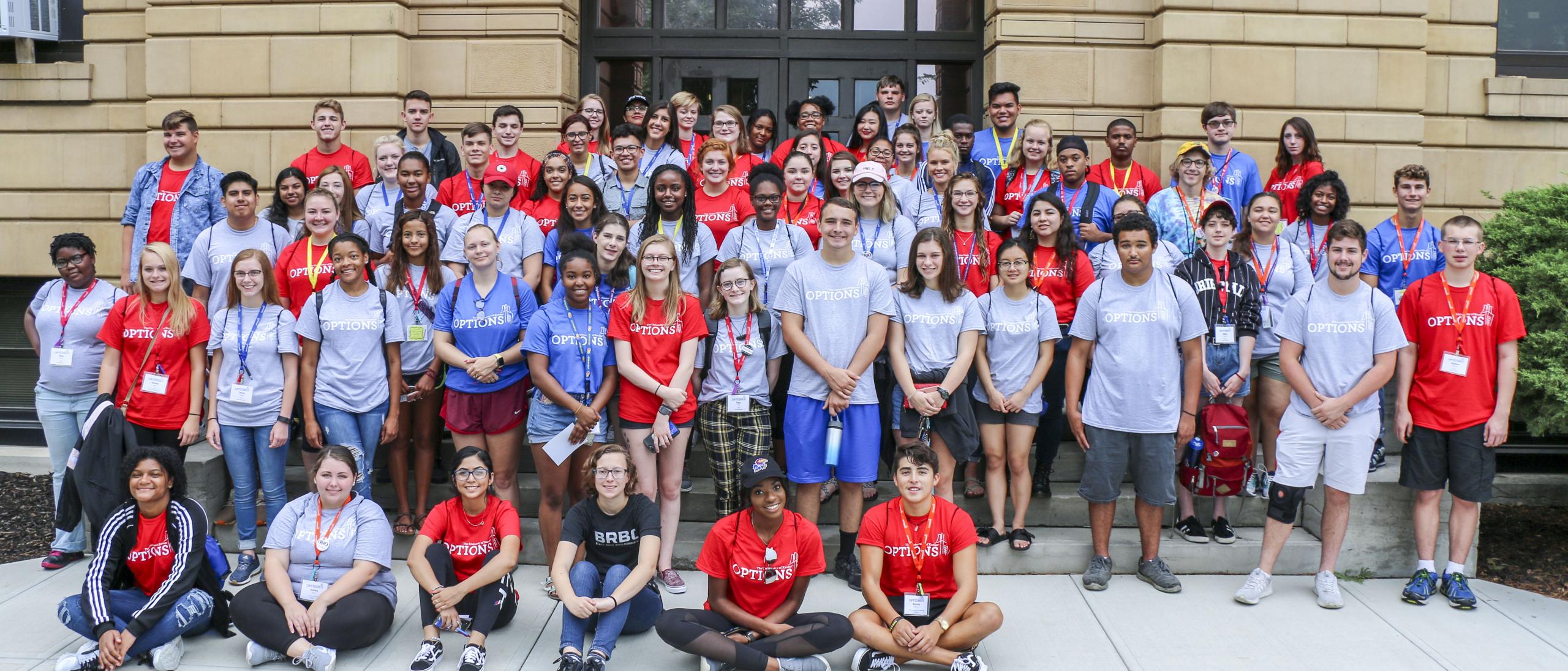 A large group of diverse undergraduates wearing matching shirts.