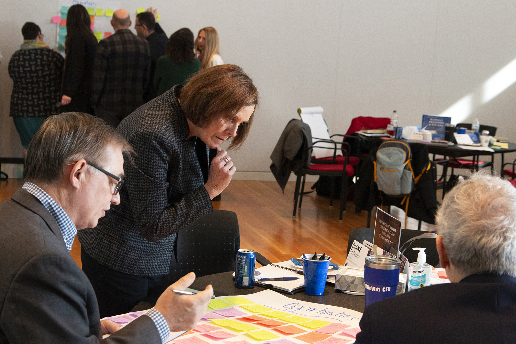 Individuals work at a table at the CBE at KU Design Charrette 